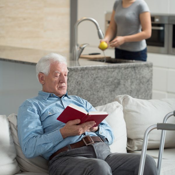 Elderly sick man resting on the couch at home
